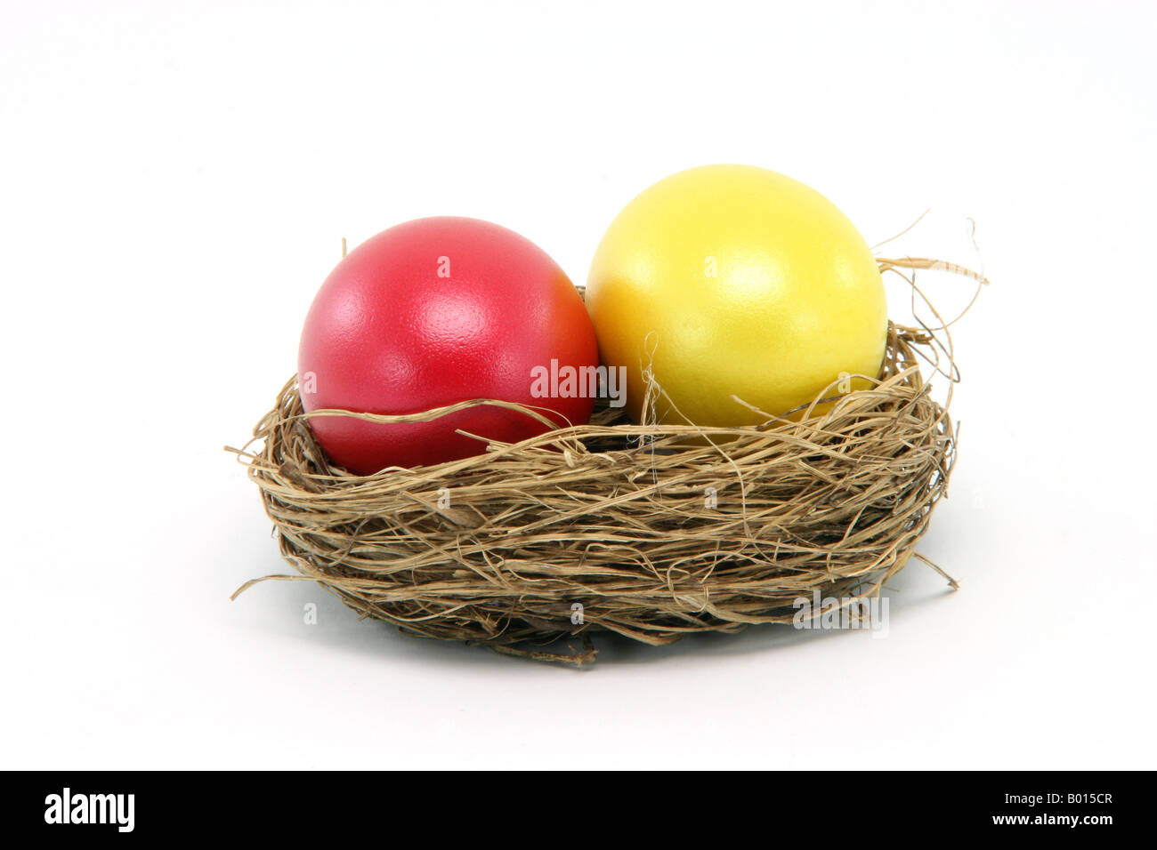 red and yellow easter egg in a nest isolated on white background seasonal Stock Photo