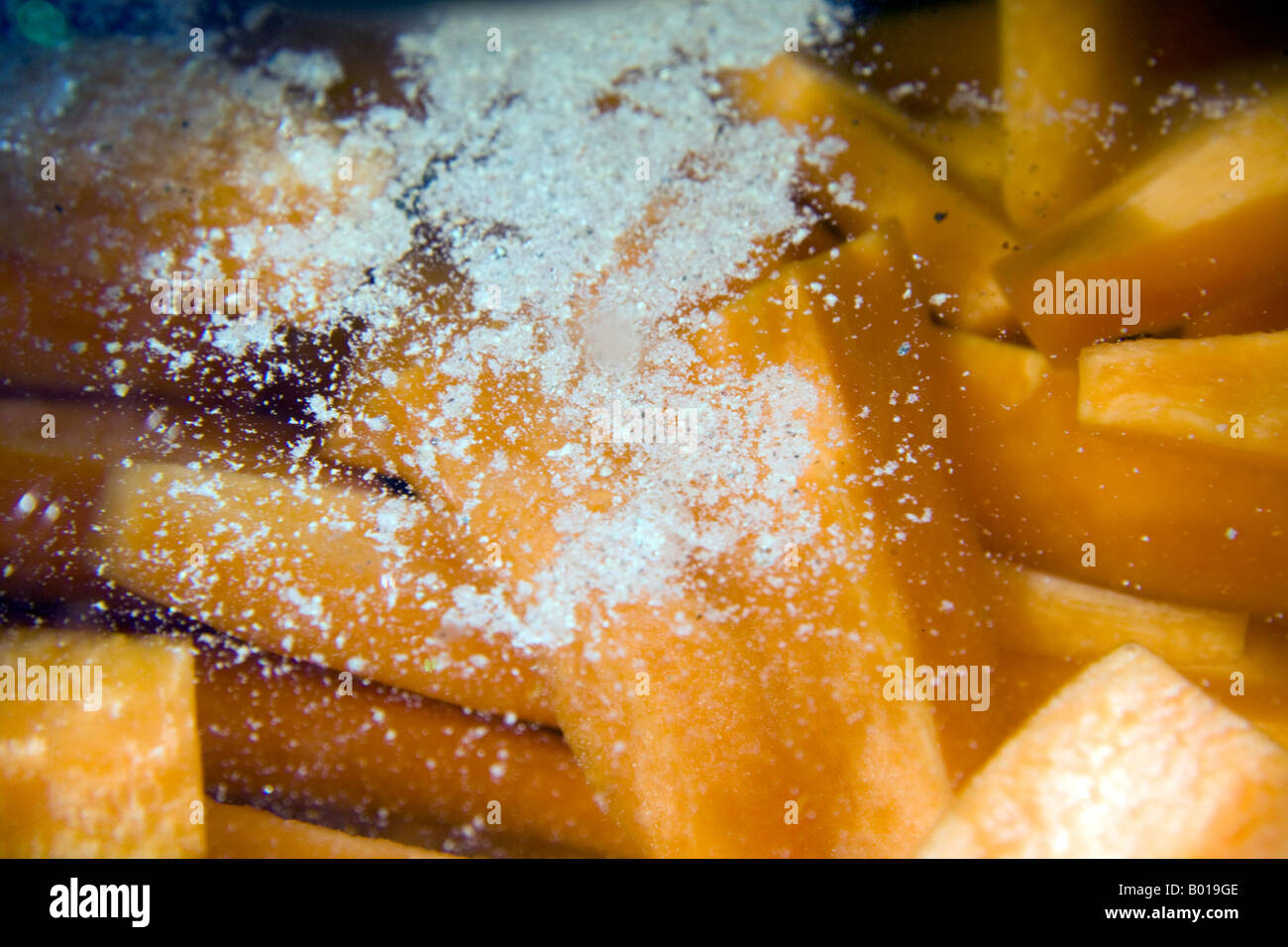 Boiling carrots with added salt. Stock Photo