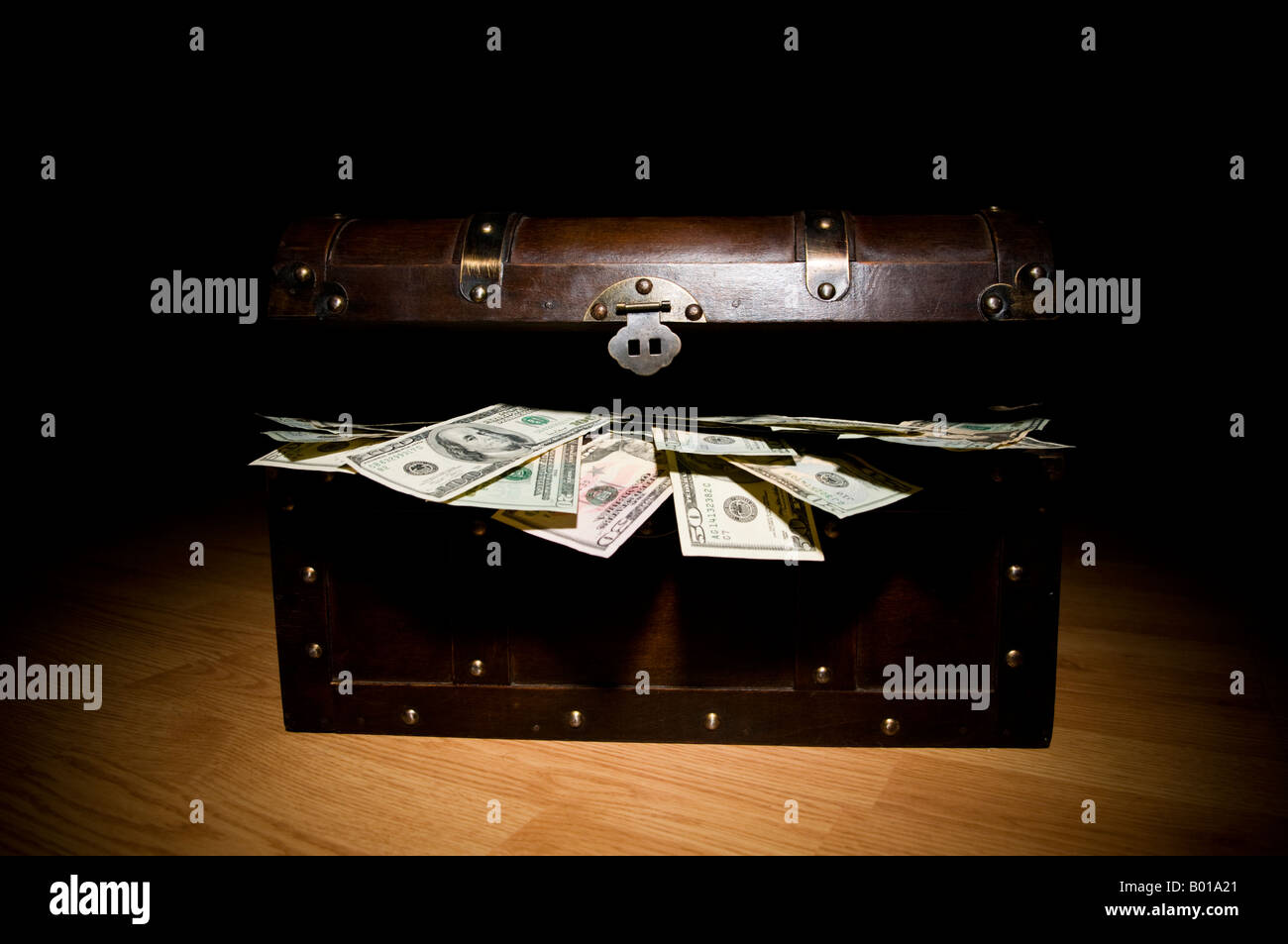 Treasure chest full of money Stock Photo