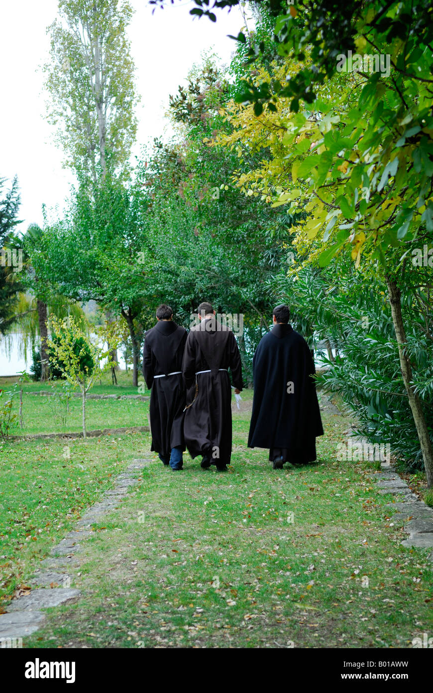 Monks walking away from camera, Krka Franciscan Monastery, island of Visovac, Krka National Park, Croatia Stock Photo