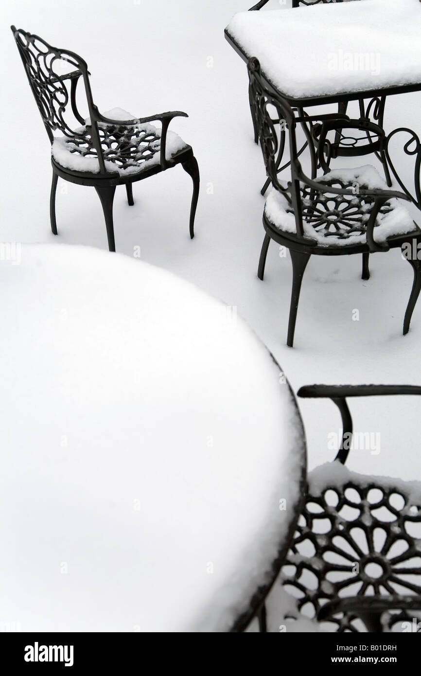 Chairs and tables all covered in snow. Stock Photo