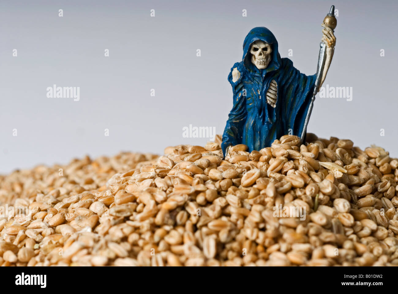 Stock photo of a model of the grim reaper standing in a pile of grain Stock Photo