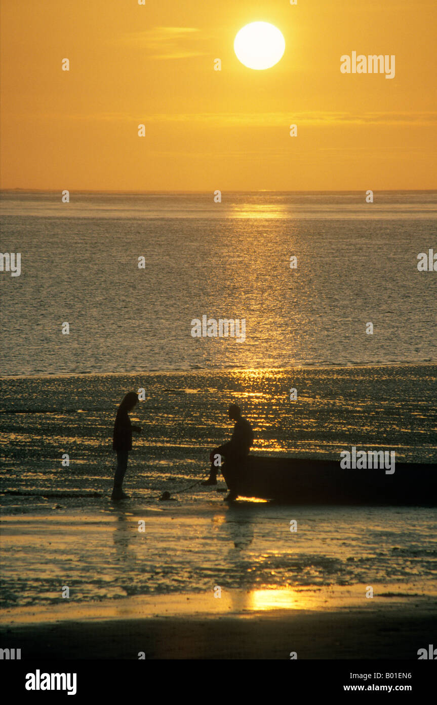 A couple silhouetted in the sunset at Instow, Devon Stock Photo