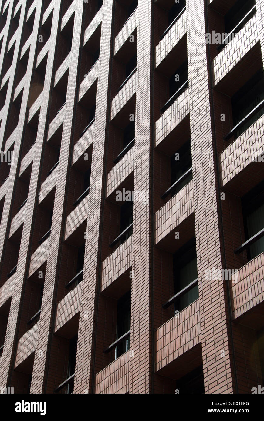 The geometric shapes of windows in a brick office building near Tokyo