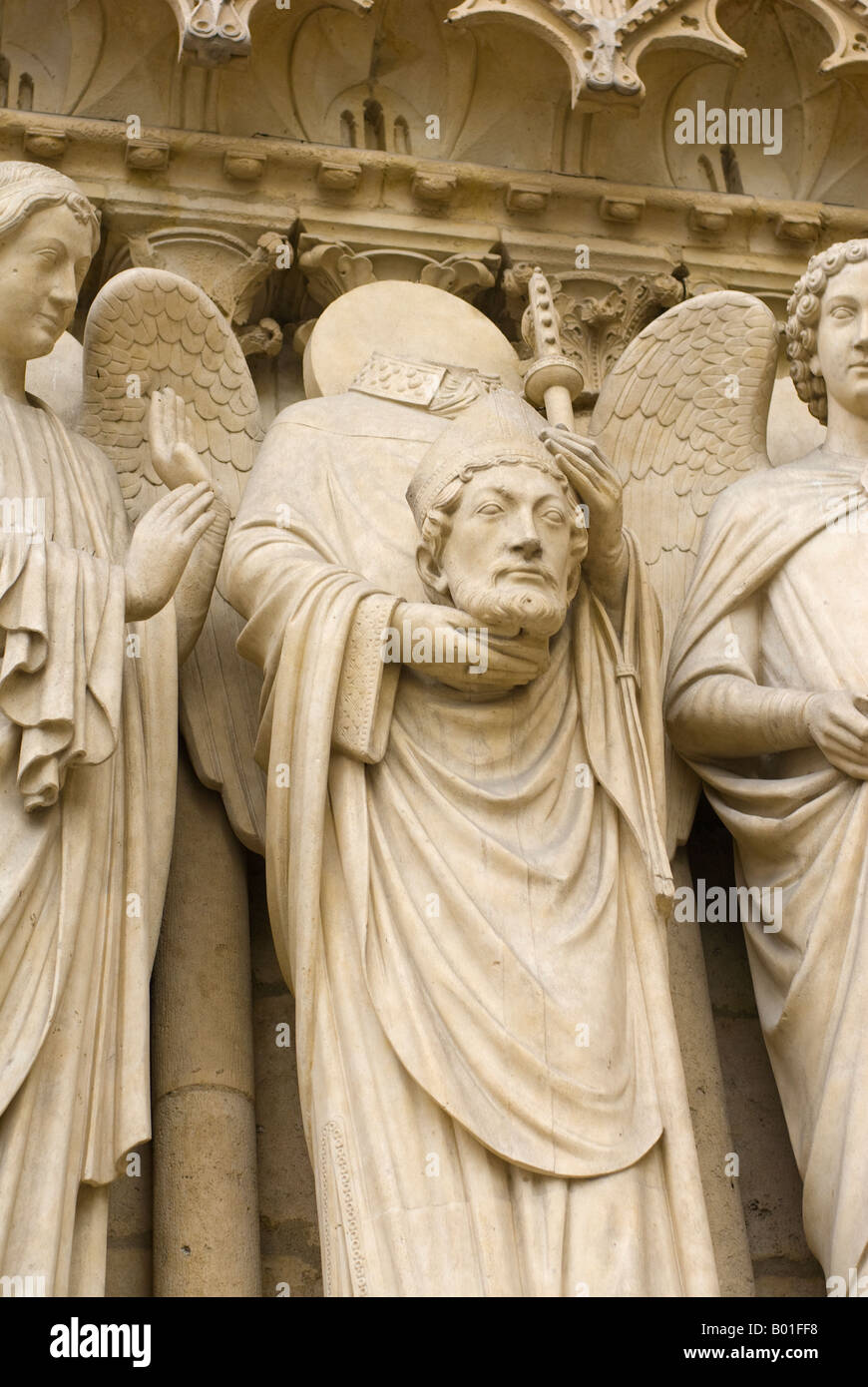 Relief statue on Notre Dame cathedral of St Denis holding his head