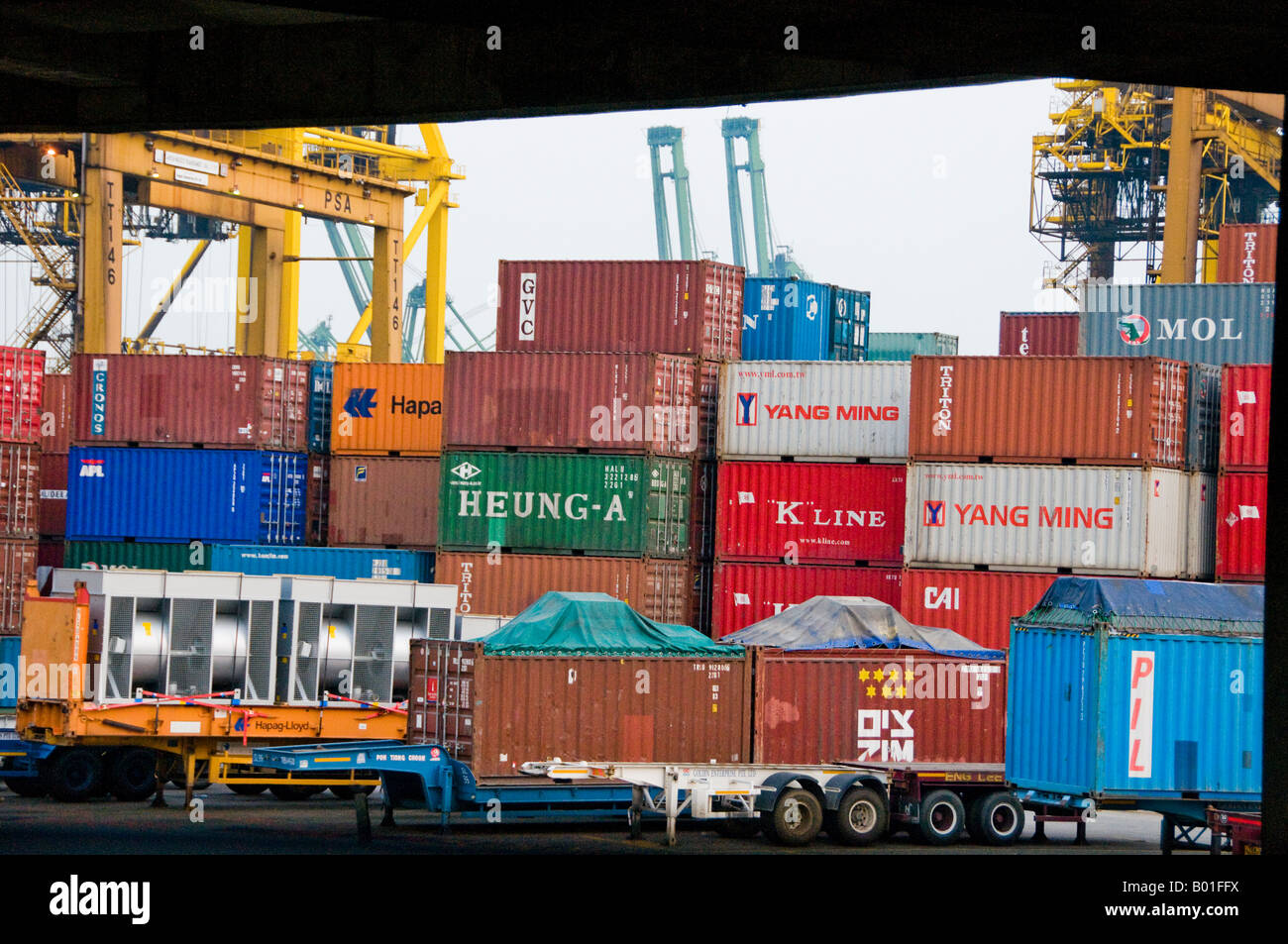 Stacks of large overseas shipping containers waiting to be loaded on