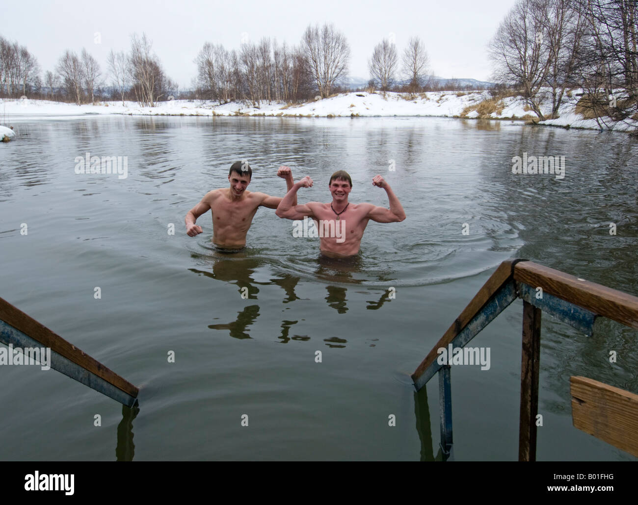 Young men swimming in lake at Ozerki natural hot springs near