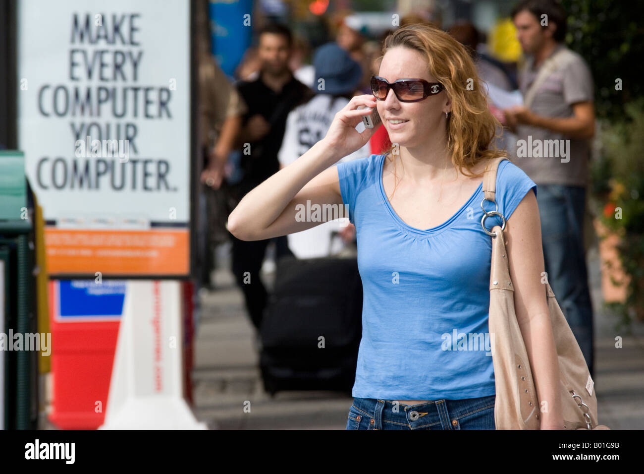 A young woman speaks on a mobile phone in Times Square, New York, USA. Stock Photo