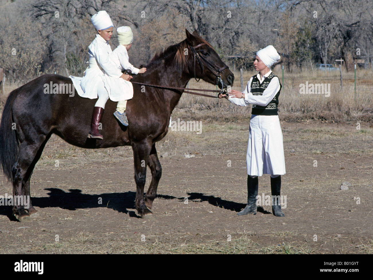 USA NEW MEXICO ESPANOLA American Sikh children ride a horse at the