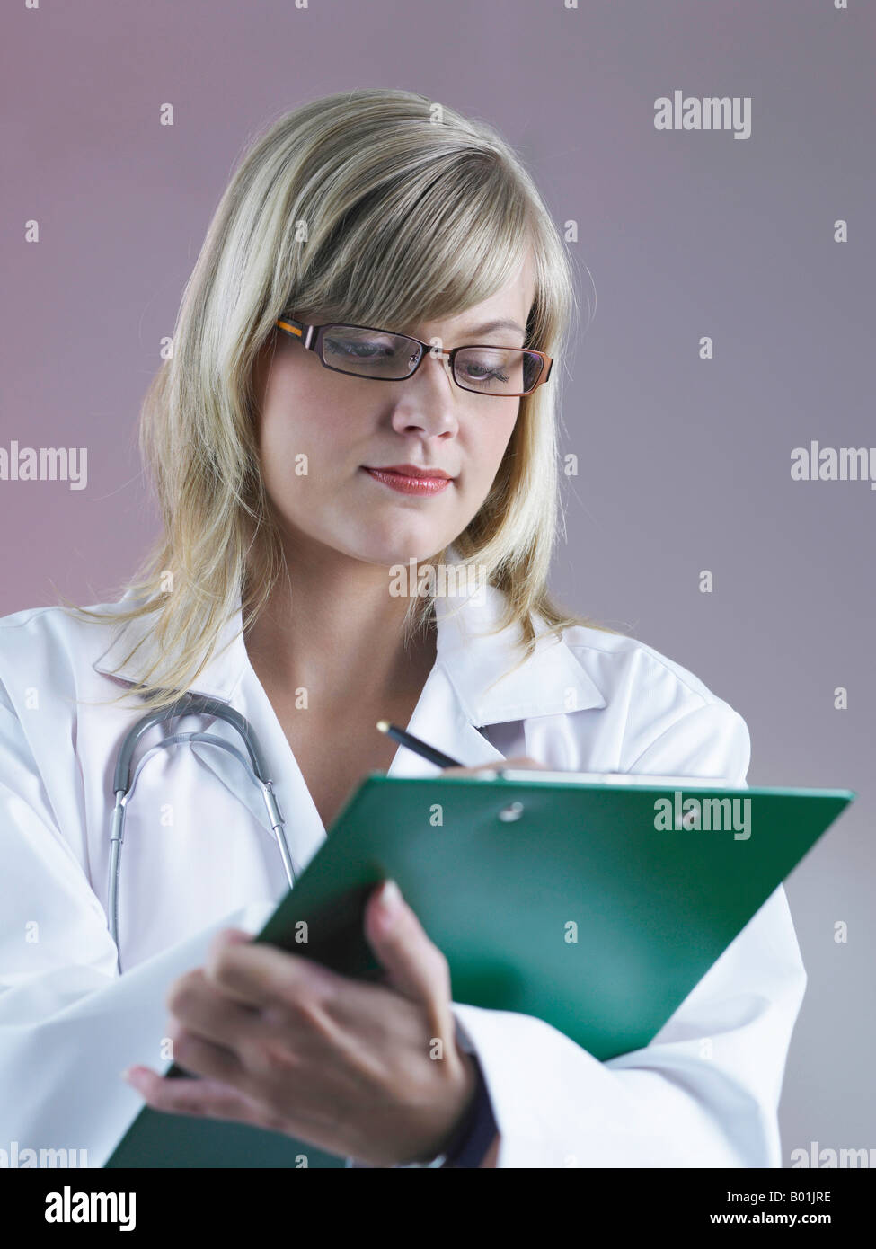 Front view of lady doctor writing Stock Photo