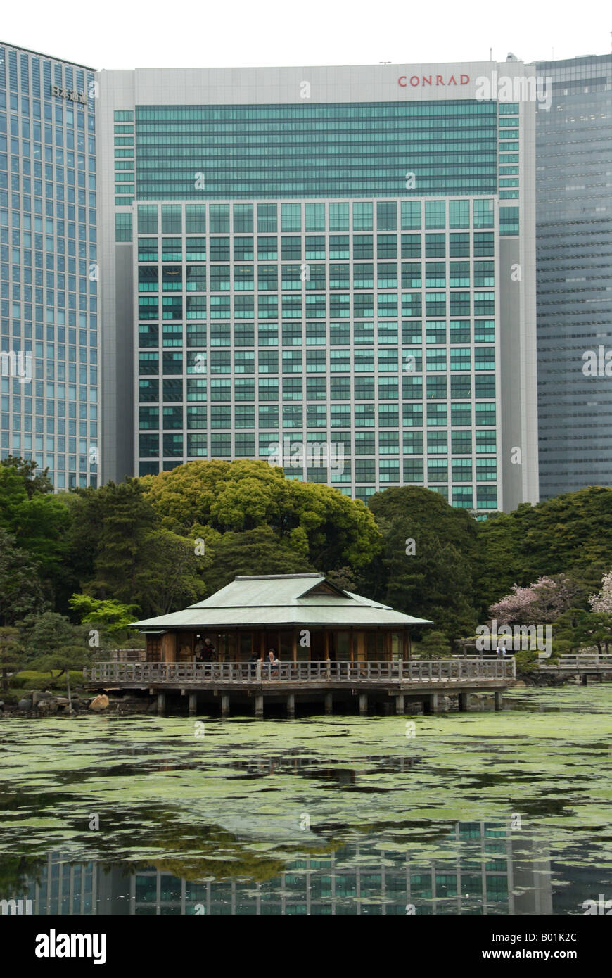 Hamarikyu Garden's Nakajima no chaya tea house with the Conrad hotel in the background, Tokyo, Japan. Stock Photo