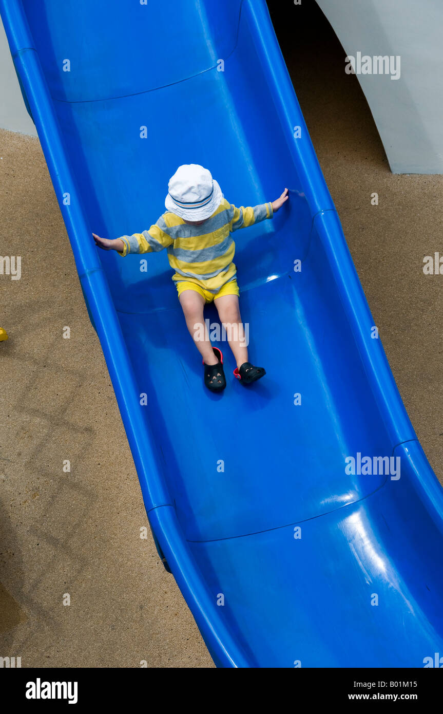 Child sliding down slide Stock Photo Alamy