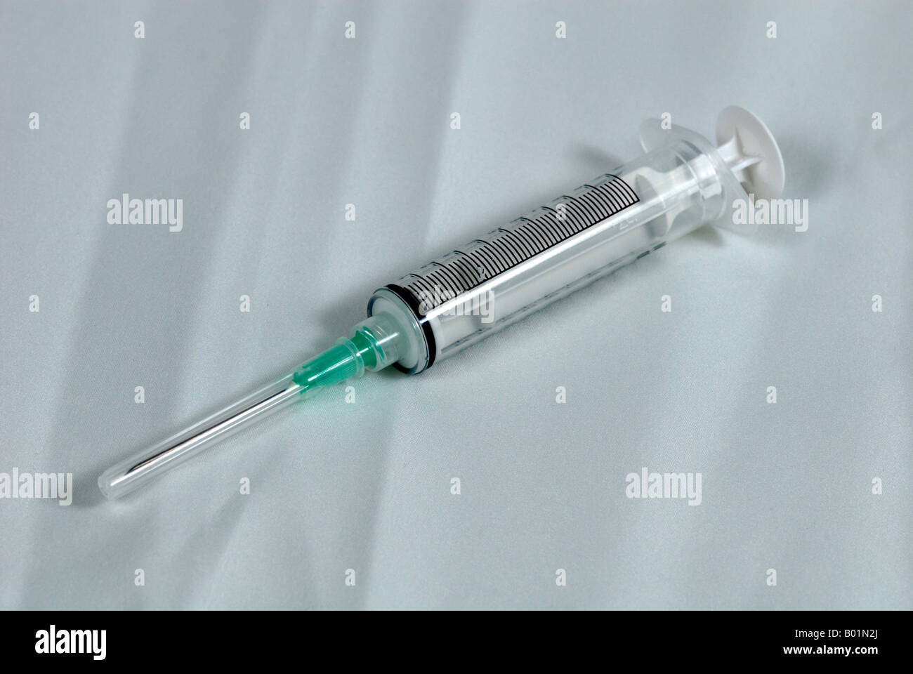 Syringe with needle attached but covered Stock Photo Alamy