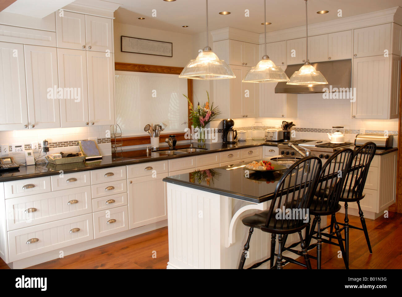 A modern kitchen brightly decorated and inviting Stock Photo - Alamy
