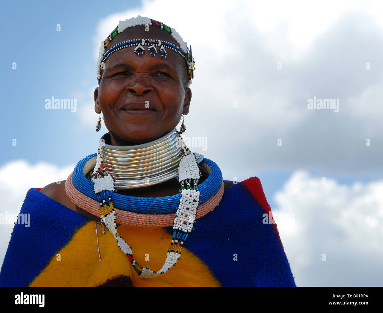 Ndebele woman in her traditional clothing in the museum village of Botshabelo in South Africa near Middelburg. Stock Photo