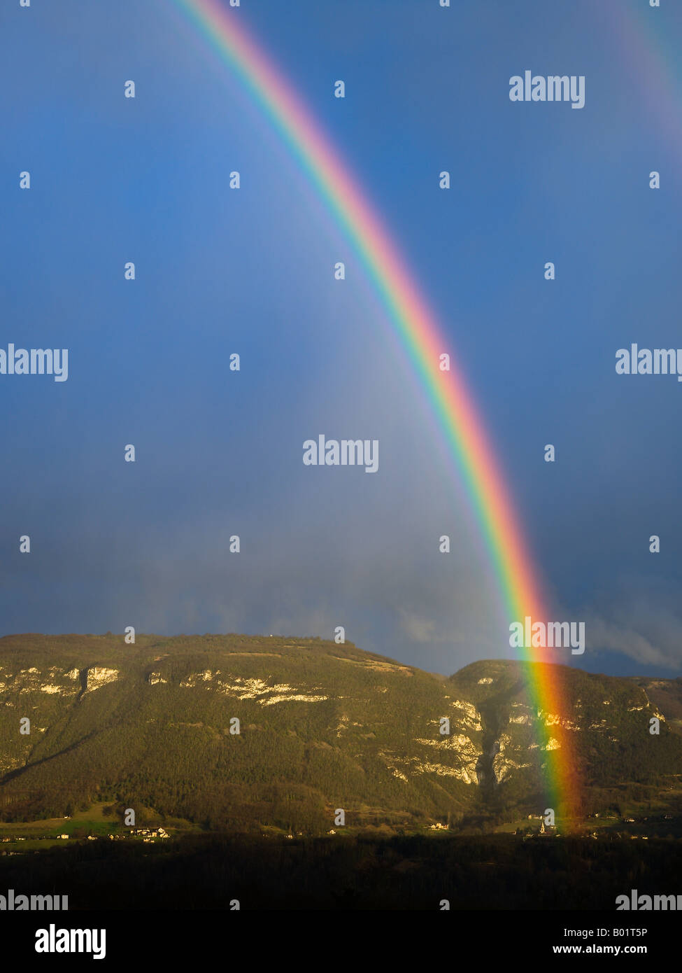 Rainbow over french Alps, France. Stock Photo