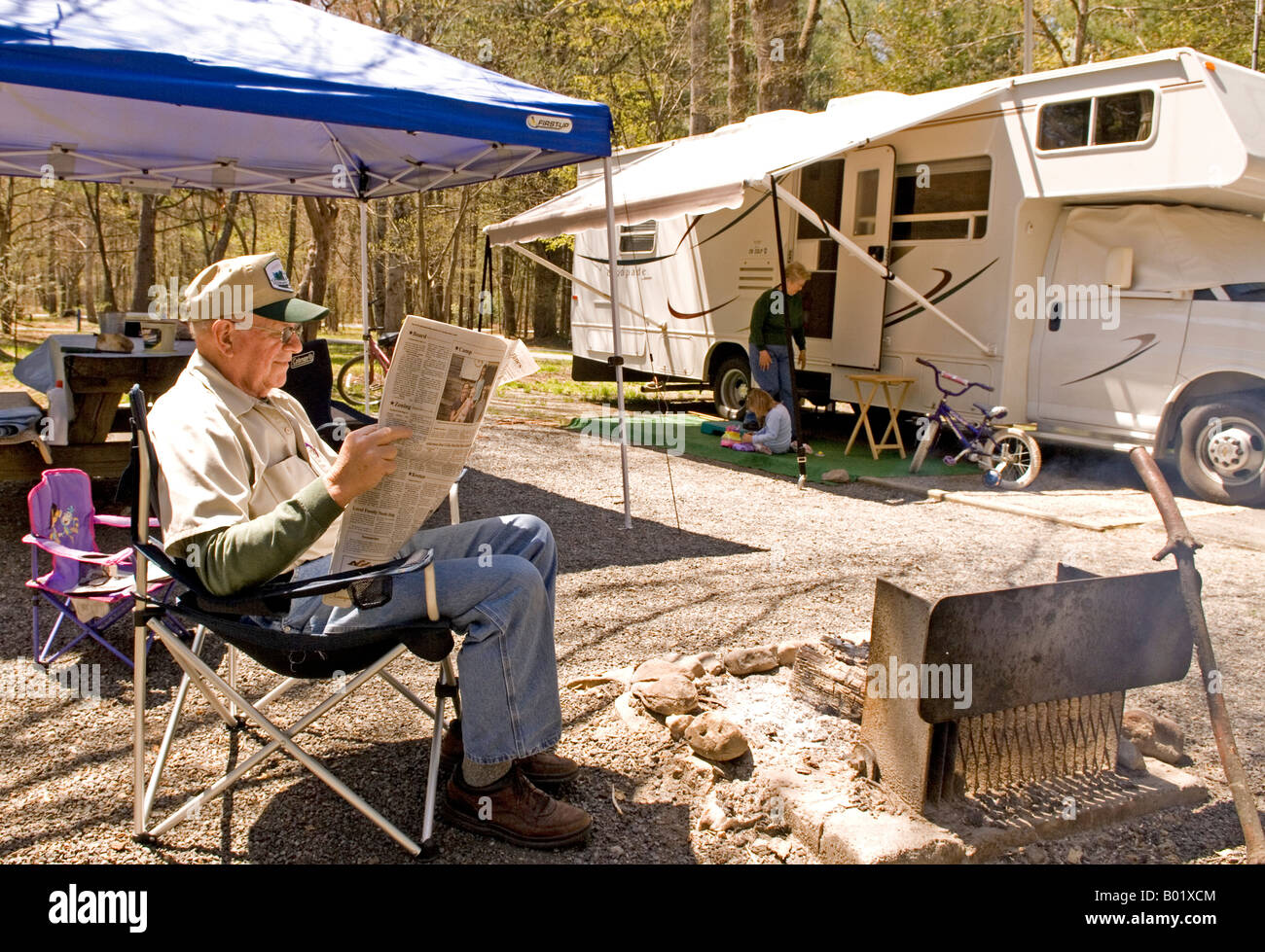 Caucasian Family Relaxes by Camper at Davidson River Campground Near Brevard North Carolina USA