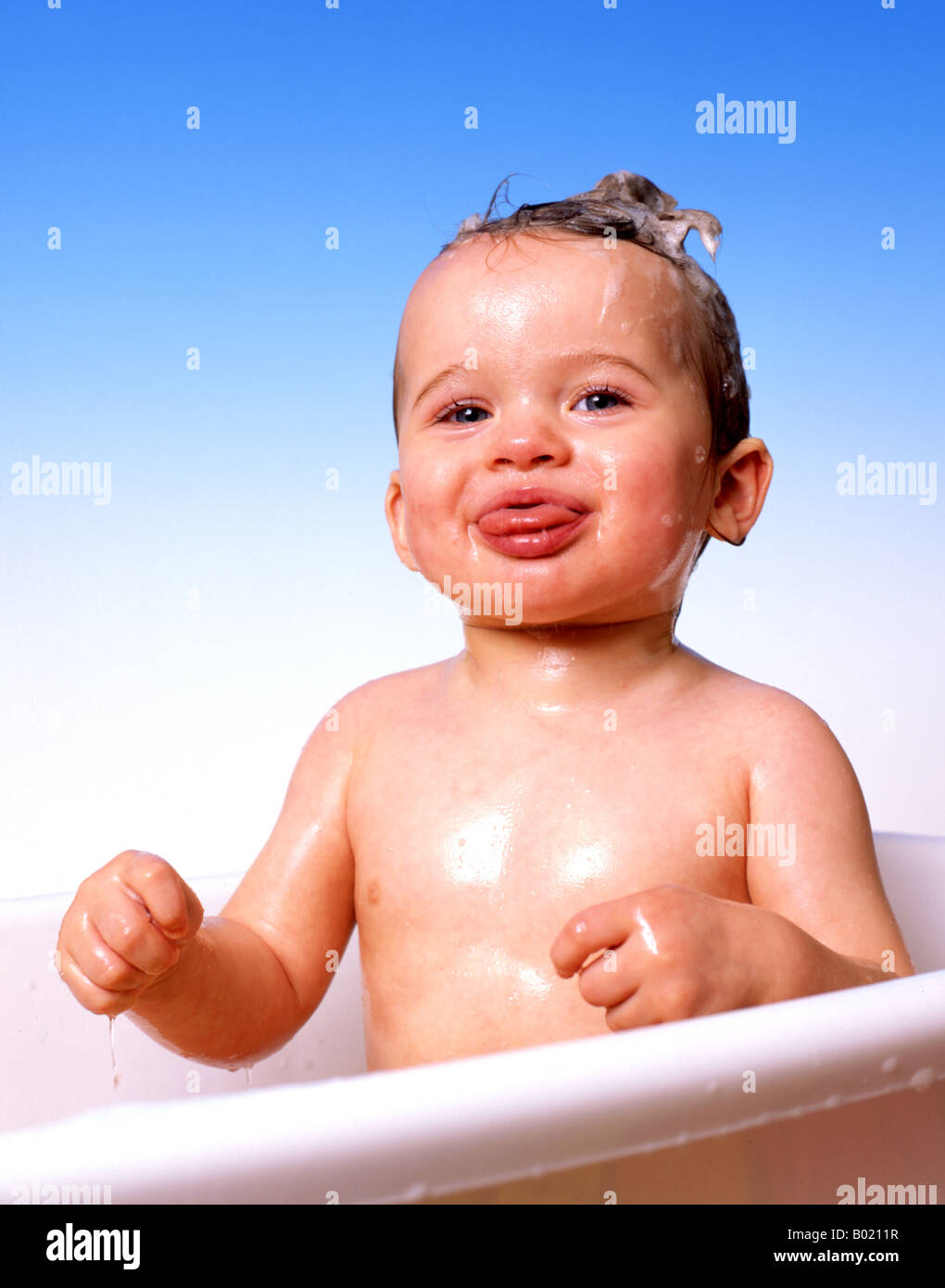 BABY BOY IN BATH PULLING TONGUE OUT Stock Photo Alamy