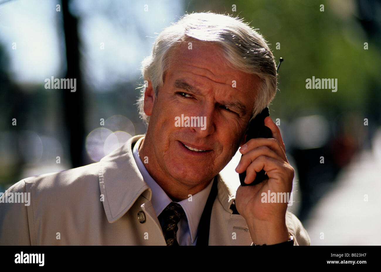 Business mature middle aged outdoor man talking on cell phone Stock Photo