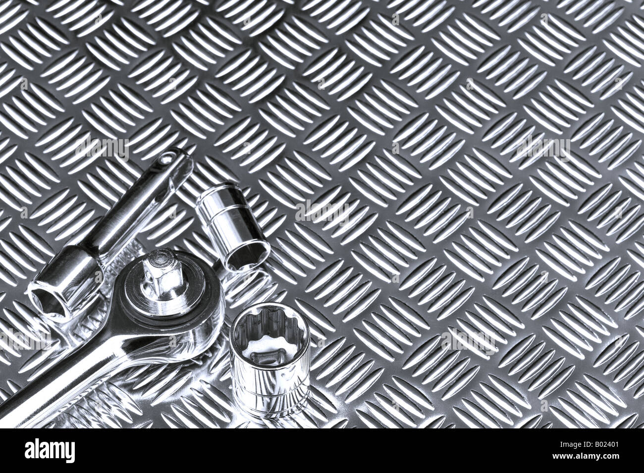 Mechanical background image of socket set on a checkerplate workbench Stock Photo