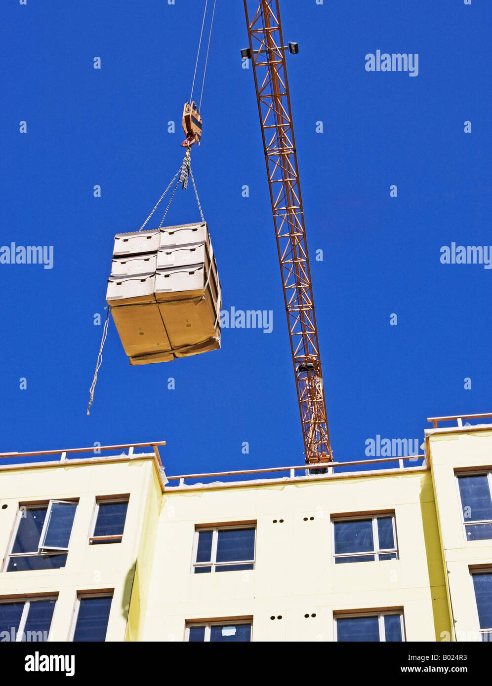 Construction crane hoist lifting crates Stock Photo Alamy