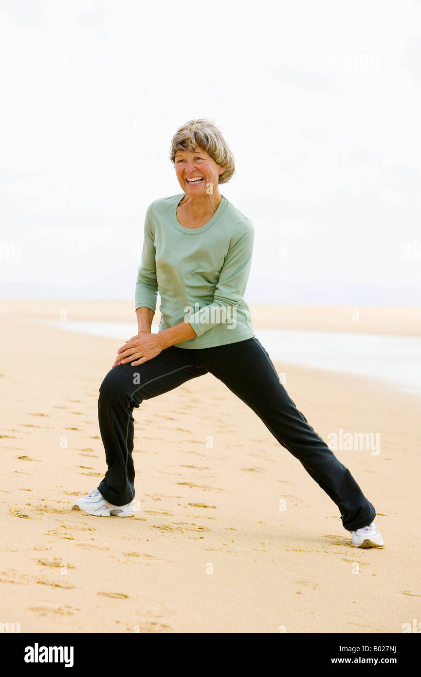 full body portrait of mature woman exercising on beach Stock Photo - Alamy