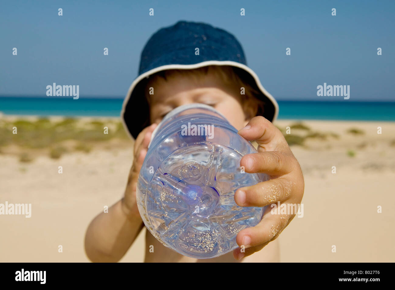 toddler drinking water from plastic bottle Stock Photo