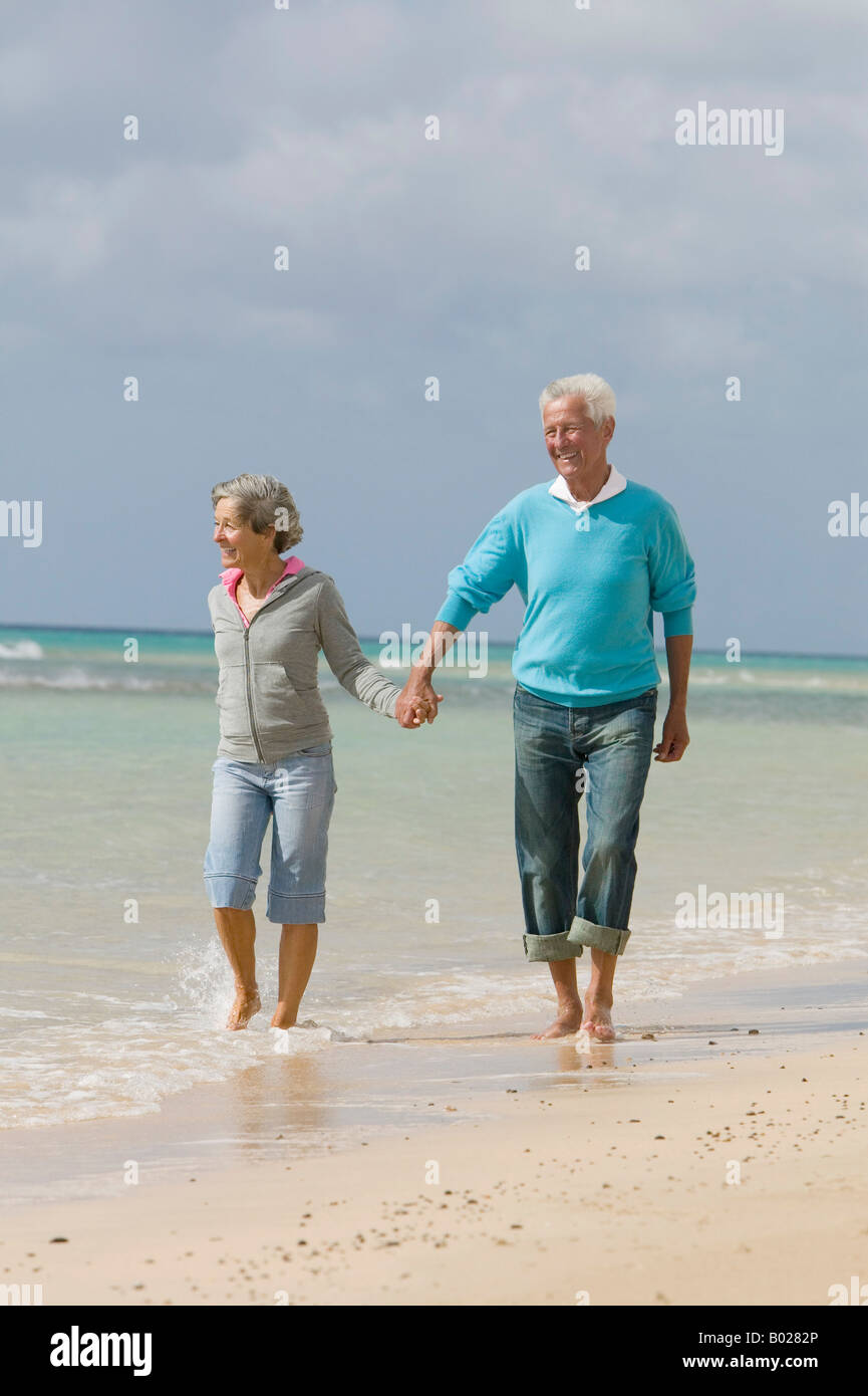 Senior man walking barefoot along hi-res stock photography and images ...