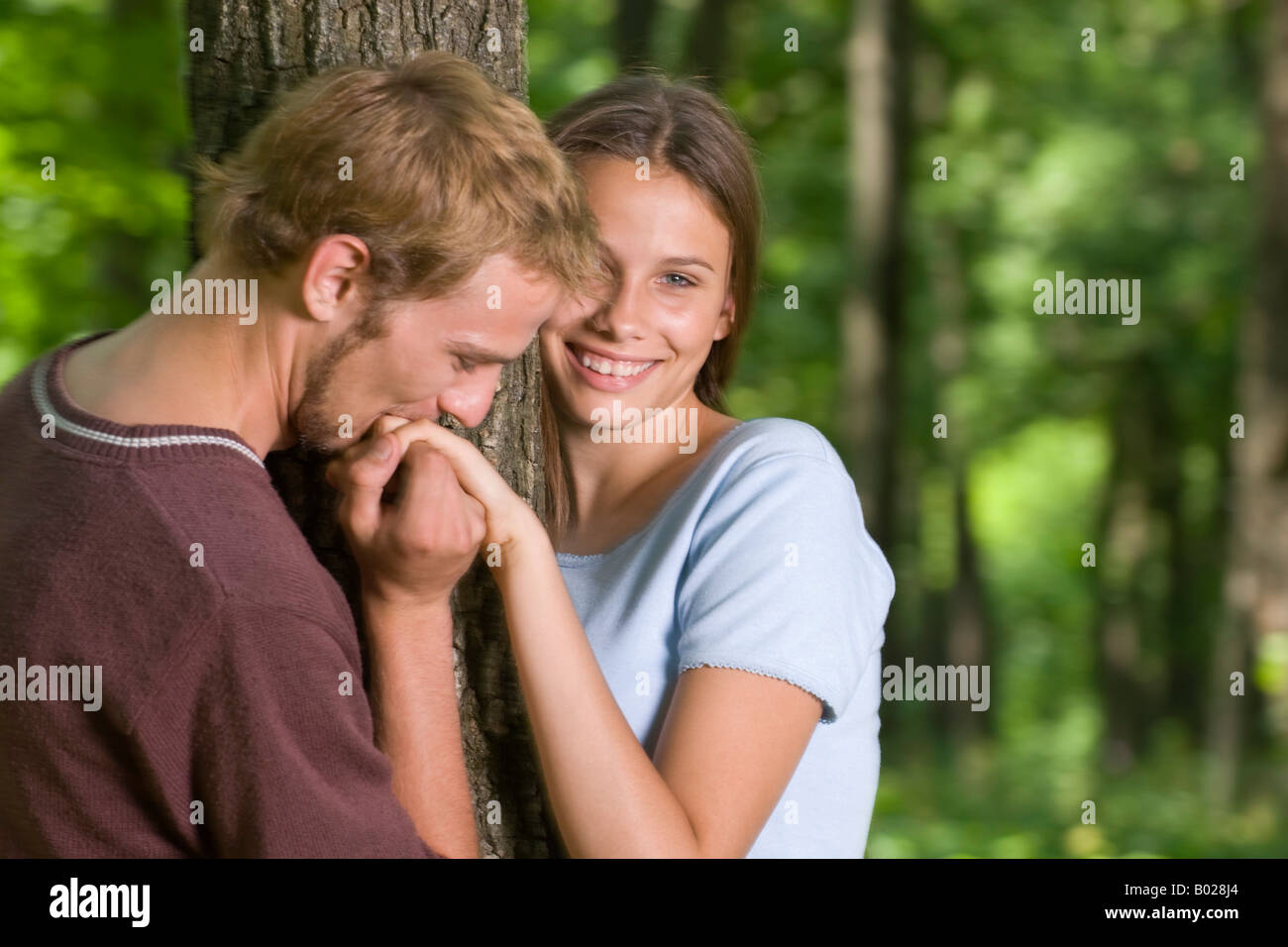 young man kissing hand of girlfriend Stock Photo Alamy