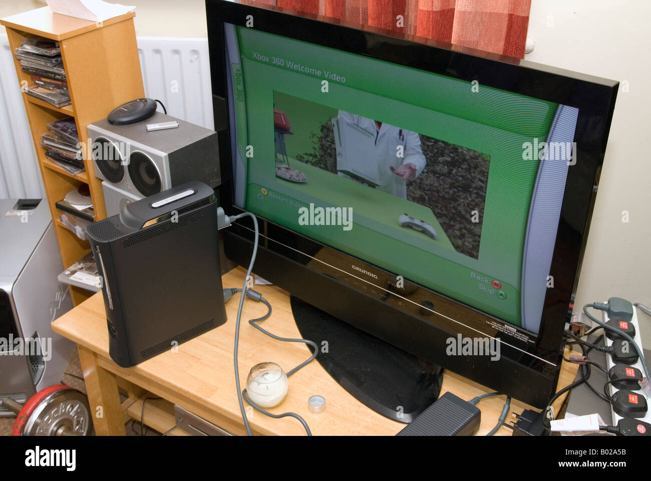 An XBox 360 being installed on a wide screen TV Stock Photo - Alamy