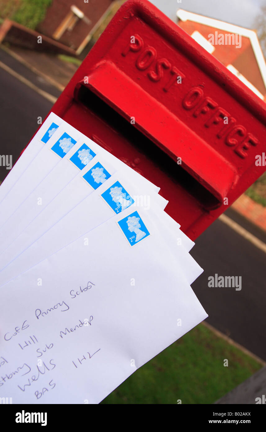 Royal Mail post box with many second class letters for mail posting