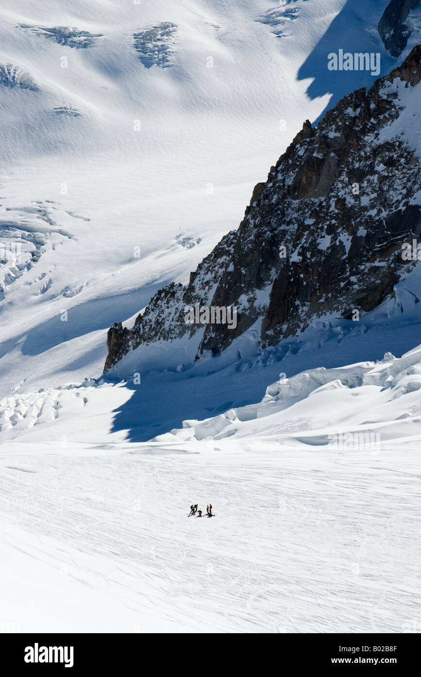 Guided group of skiers on highly crevassed Petit Envers variant of Vallee Blanche, Aiguille du Midi, Chamonix, France Stock Photo