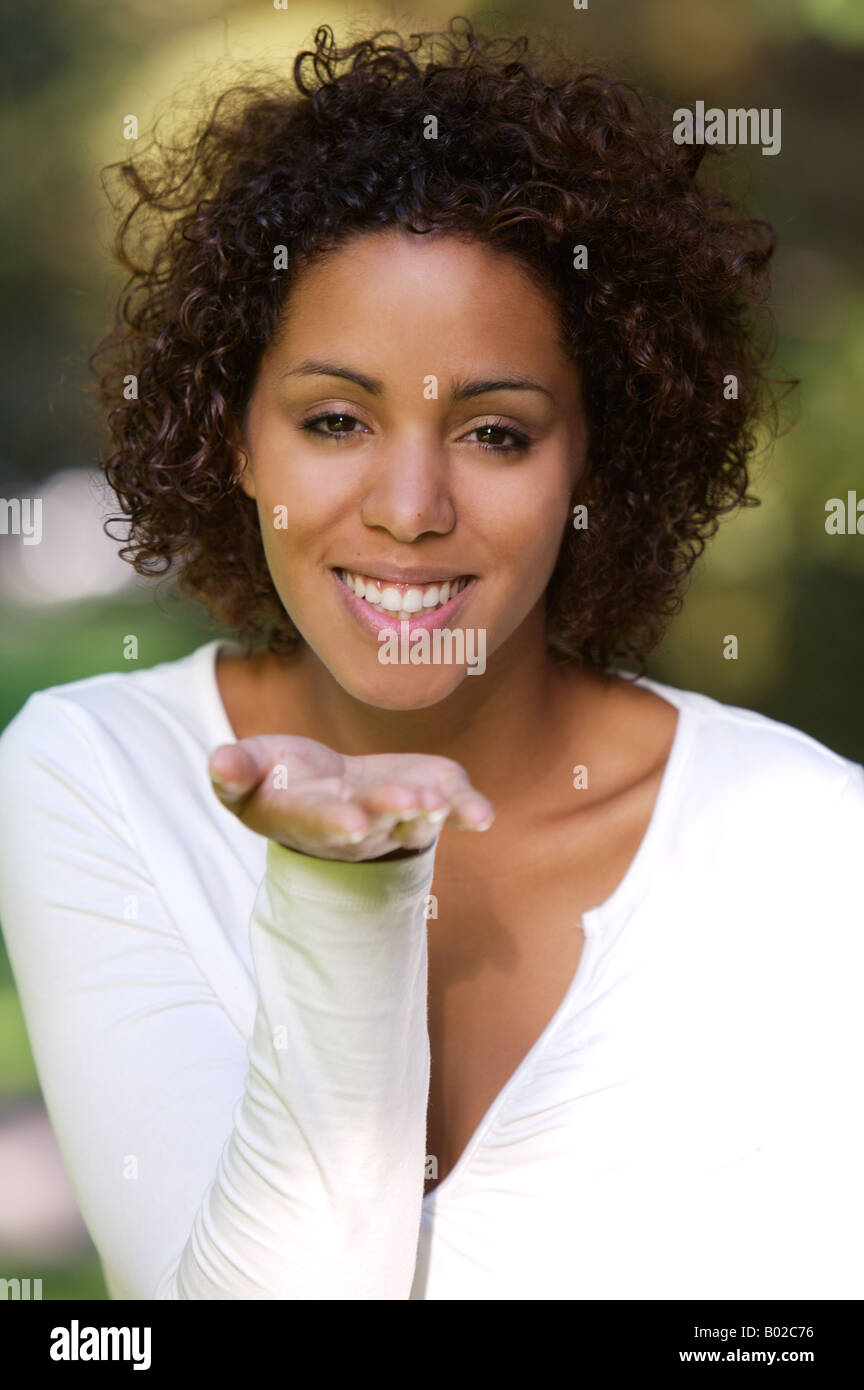 Young African mulata woman half German half Cuban blowing a kiss