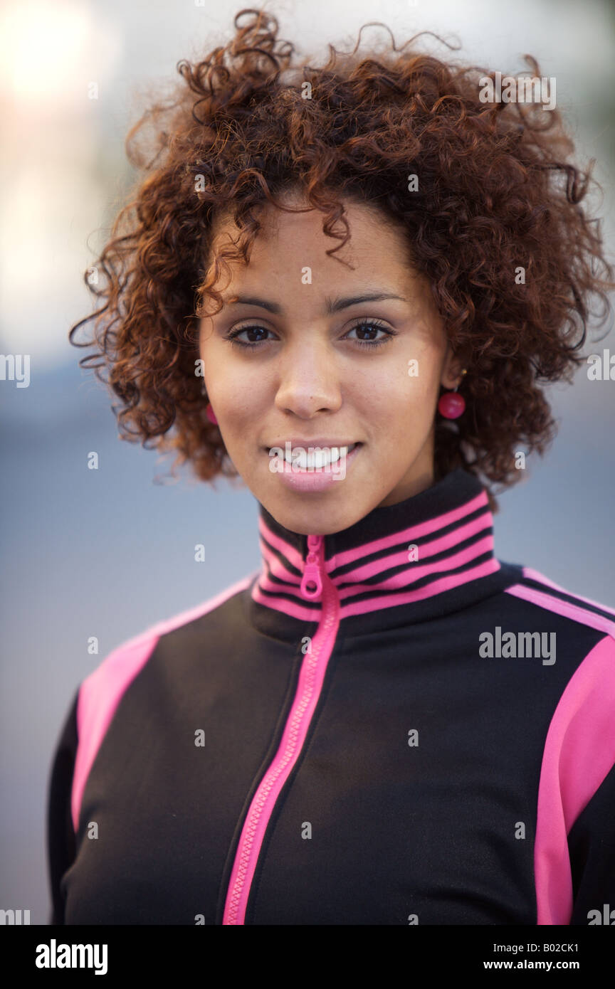 Girl smiling, in sports jacket, ethnic background of model half German half Cuban Stock Photo