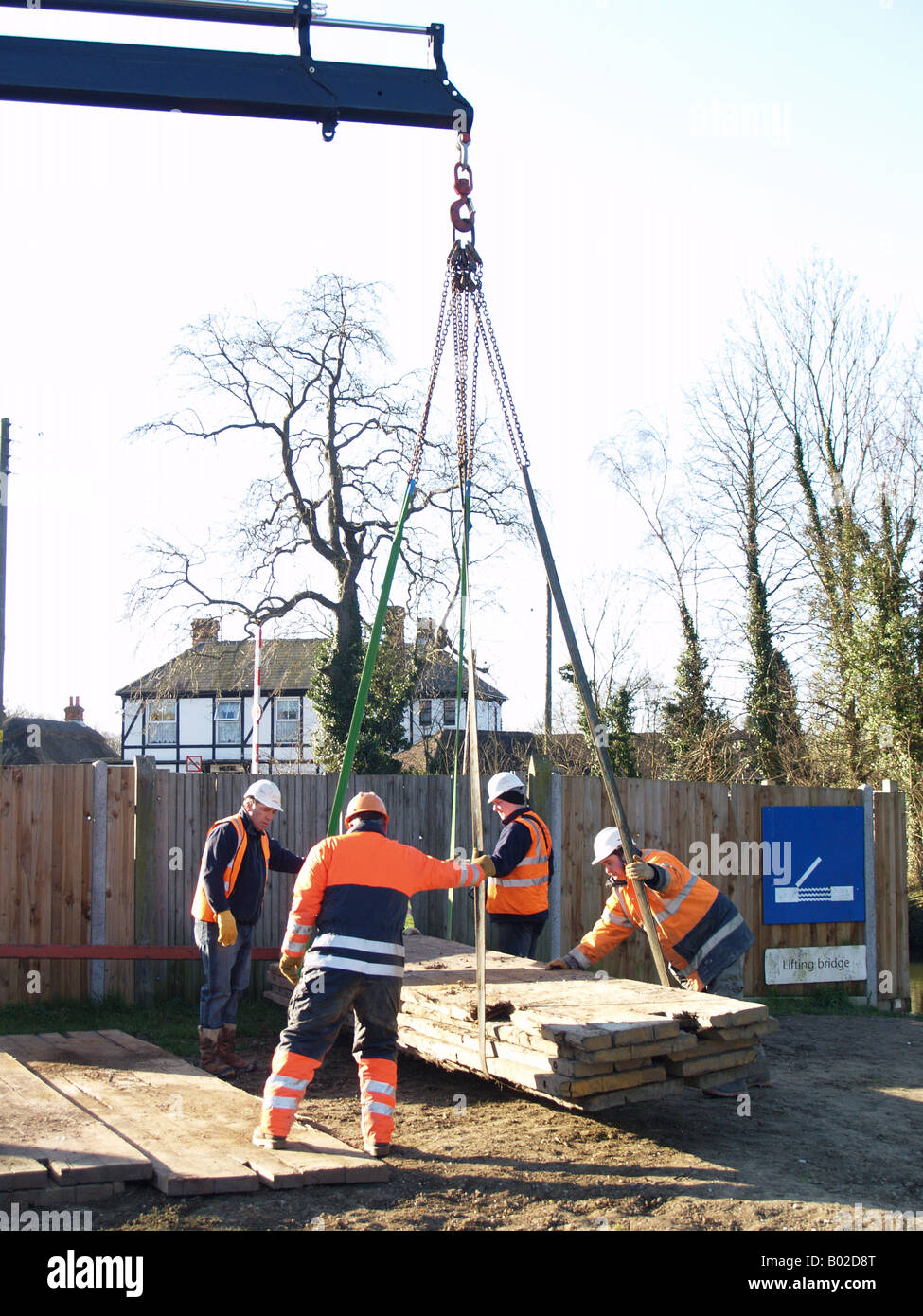 worker crane lifting large wooden decking platform Stock Photo Alamy