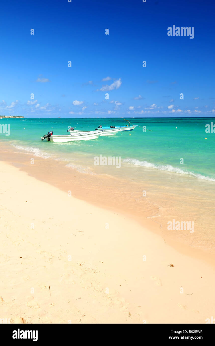 Fishing boats in Caribbean sea anchored near sandy beach Stock Photo