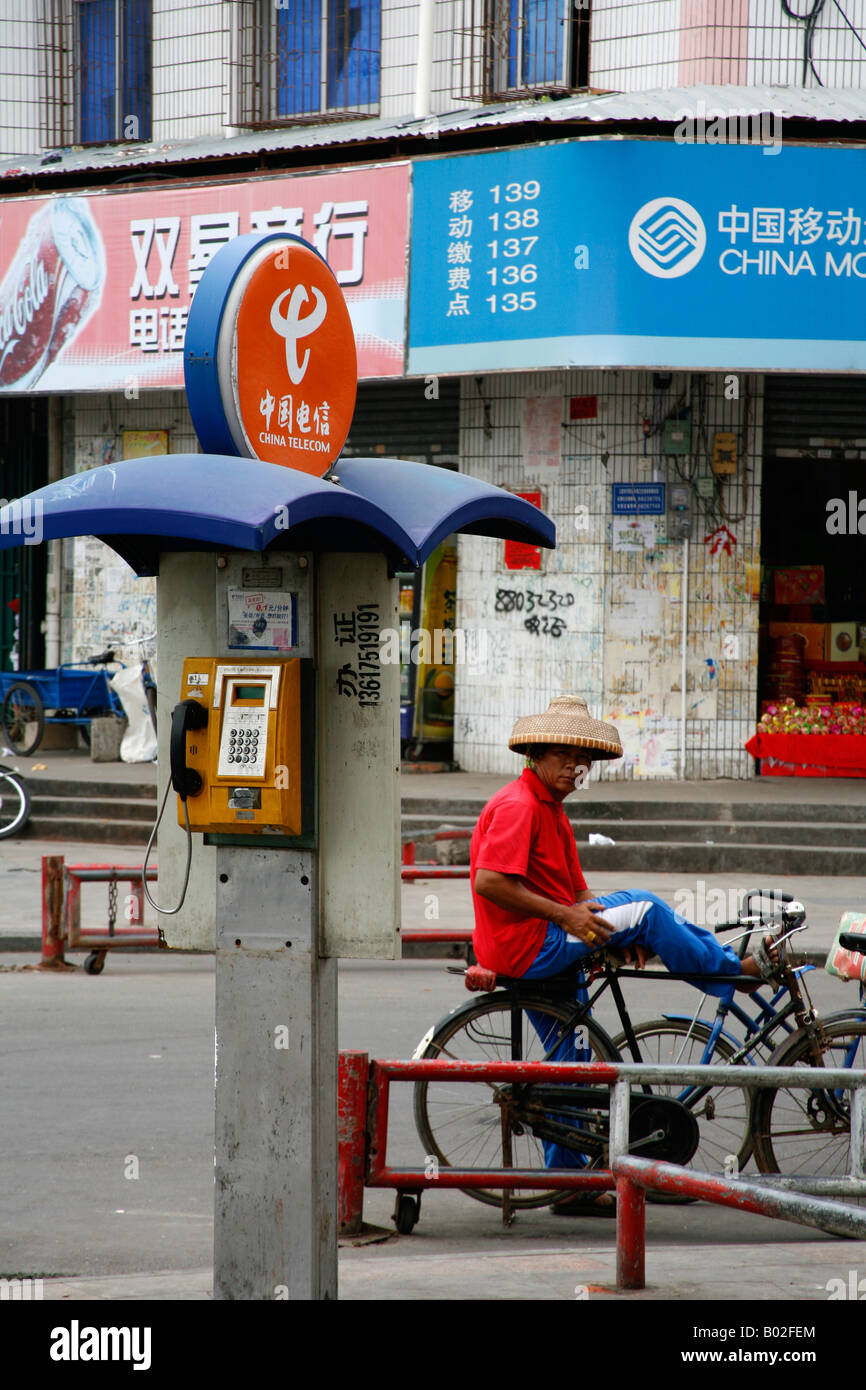 Local man on bicycle in Sanya town Hainan Island China September 2007 Stock Photo