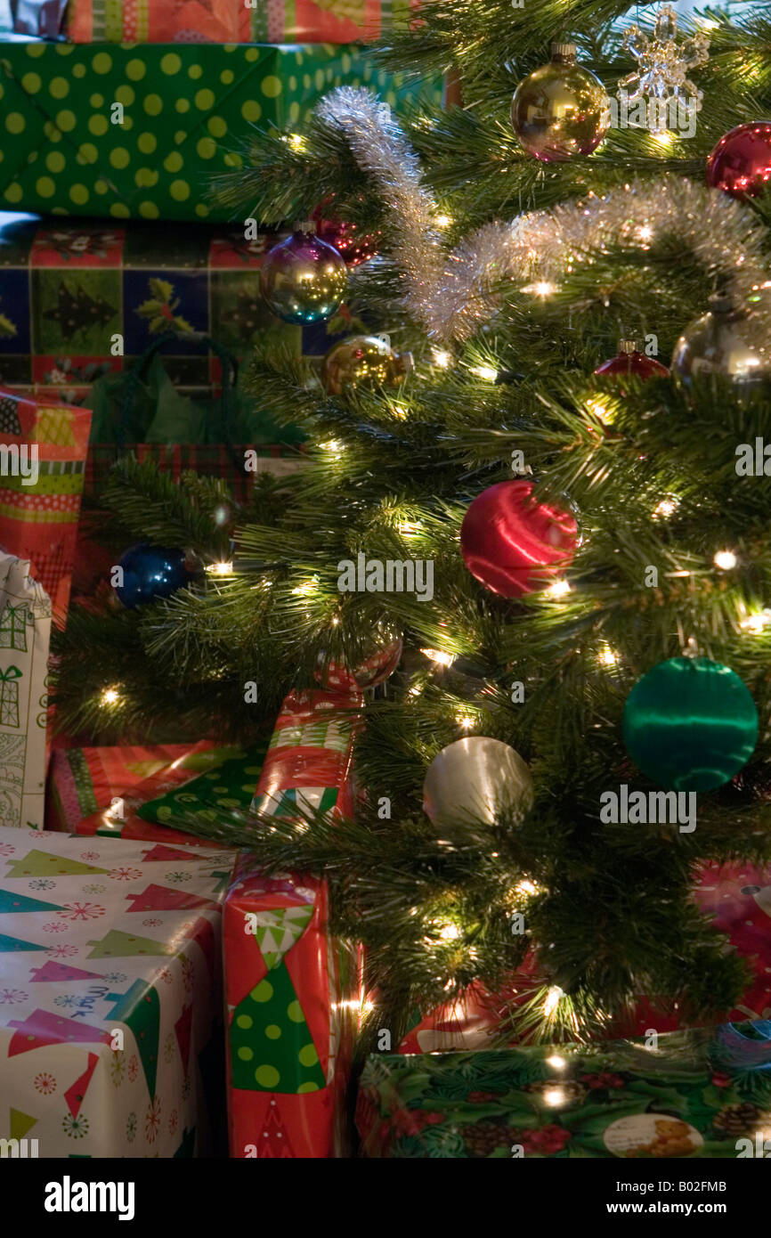 Wrapped Christmas presents under Christmas tree. Christmas lights