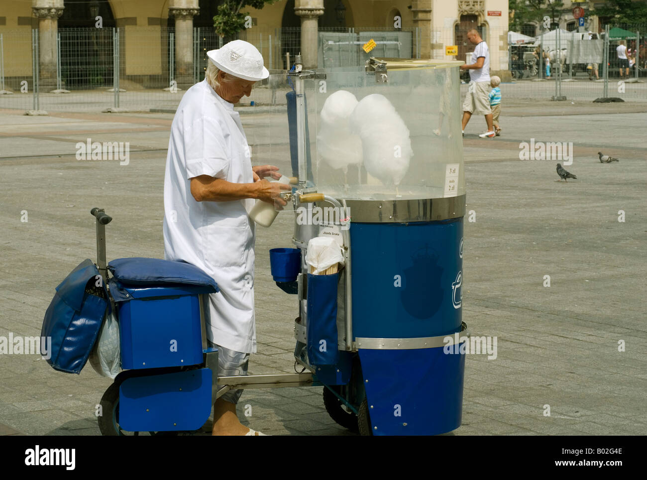 Woman selling white candy floss from blue scooter in Rynek Glowny medieval market square in Krakow,Poland,Eastern Europe Stock Photo
