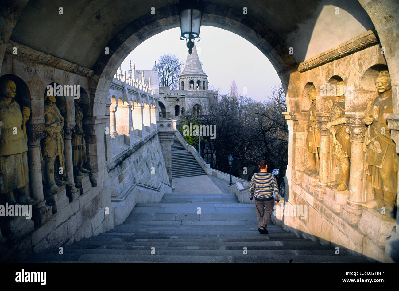 Man walking down ornate steps Stock Photo