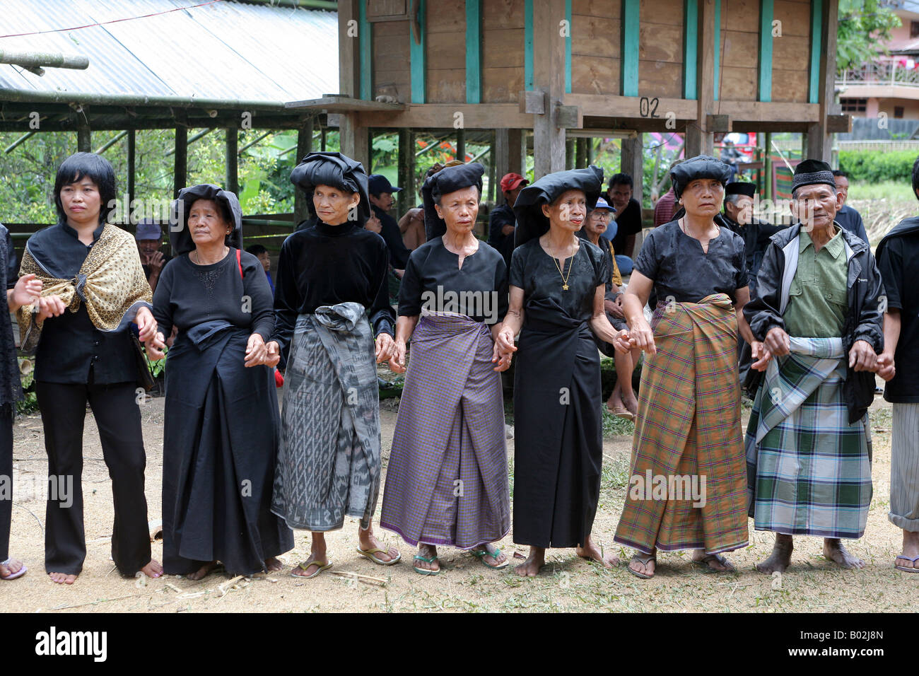 Indonesia Sulawesi Tana Toraja: traditional funeral. Family members, relatives and friends mourning in black clothes Stock Photo