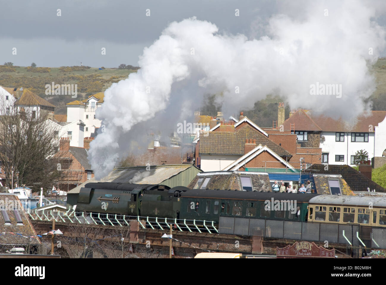 A steam charter train headed by 34067 'Tangmere' leaving Folkestone Harbour. Stock Photo
