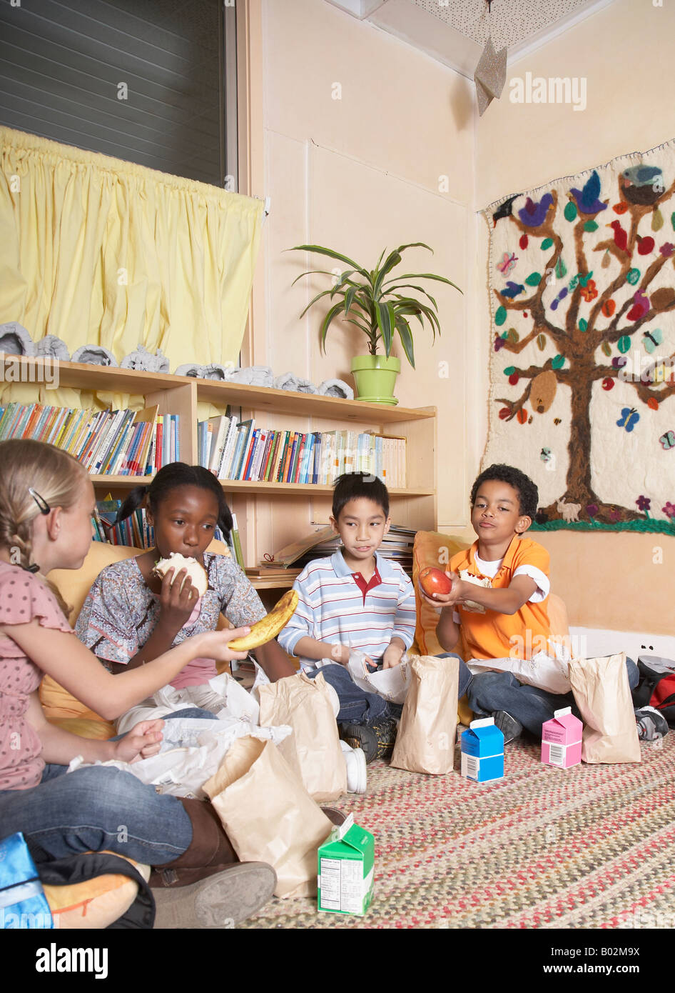 Multi-ethnic school children eating lunch Stock Photo