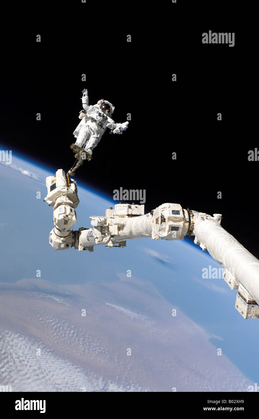 Astronaut anchored to a foot restraint. Stock Photo