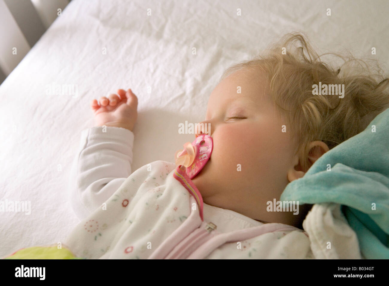 Little baby girl is sleeping in her bed Stock Photo - Alamy