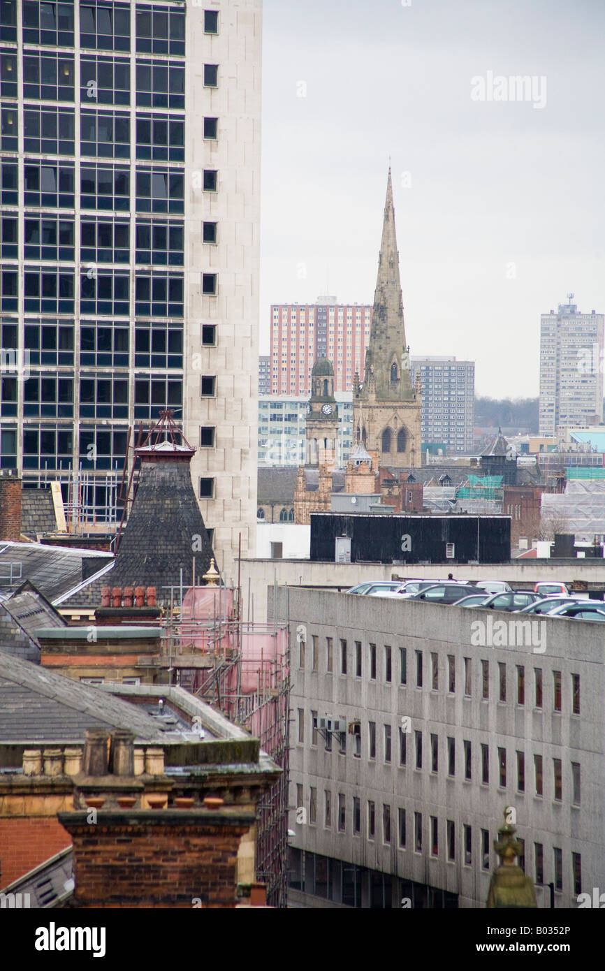 Urban view over the rooftops of Manchester looking at the spire of Salford Cathedral Greater Manchester UK Stock Photo