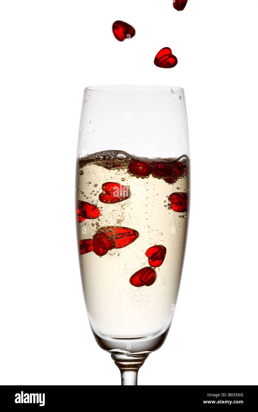 Hearts falling down into champagne flute. Stock Photo
