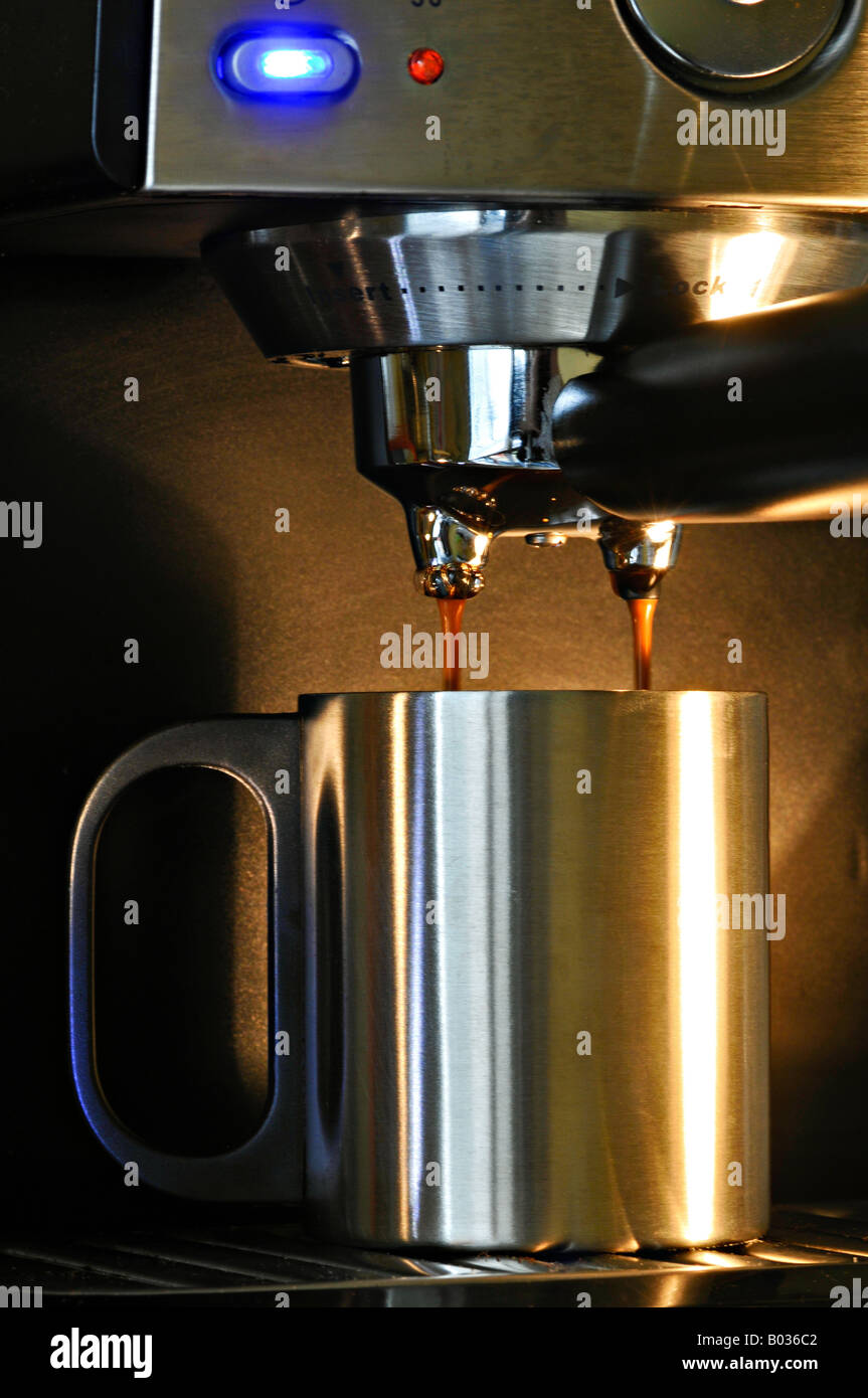Coffee pouring from an espresso machine Stock Photo