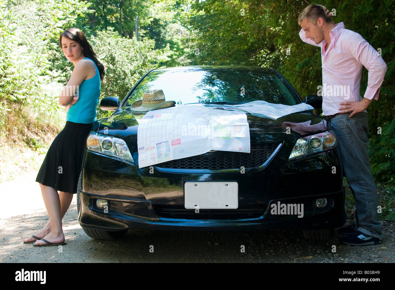 A young couple tries to figure out the directions ona road trip Stock