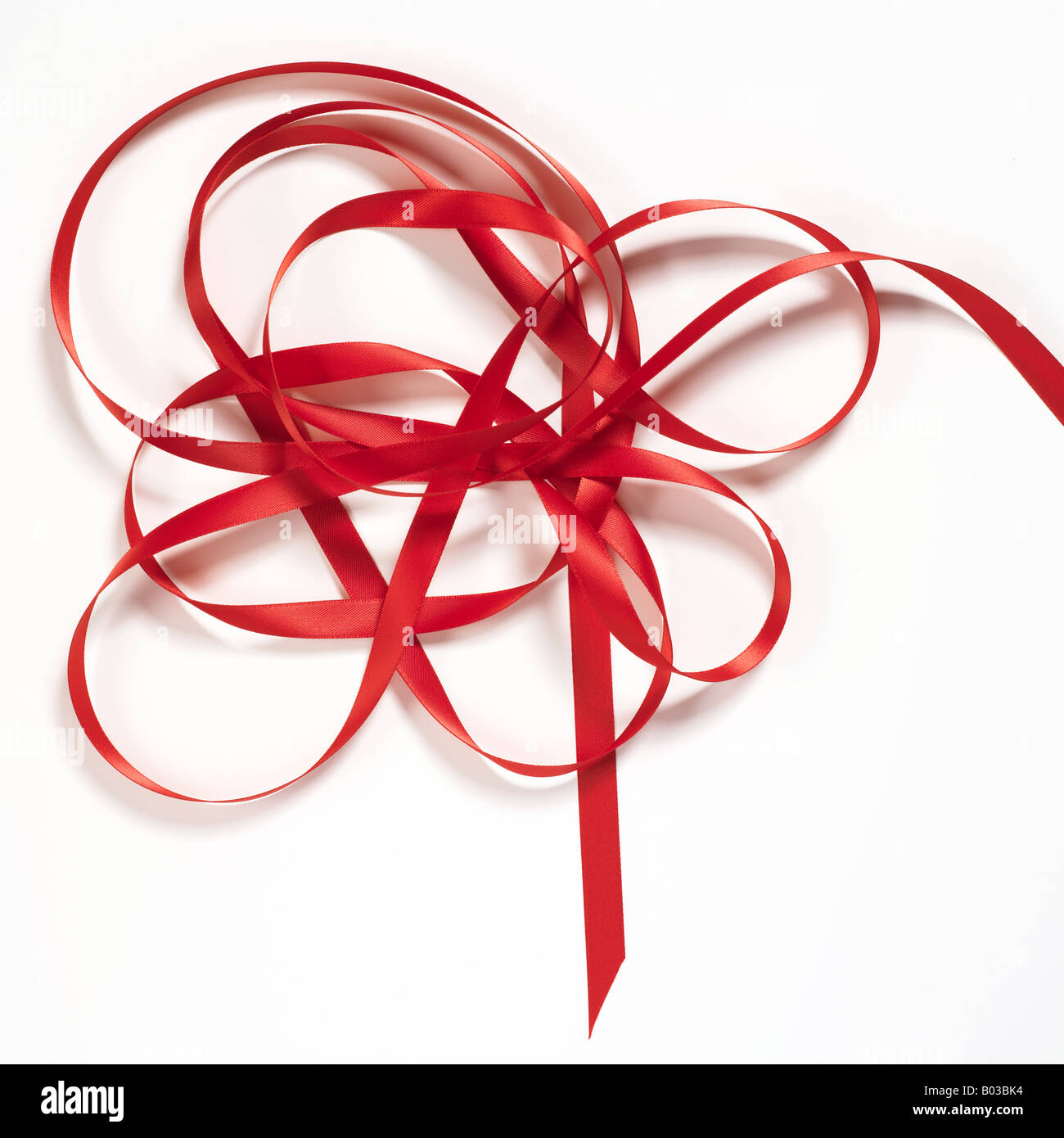 red satin ribbon curls on white background Stock Photo